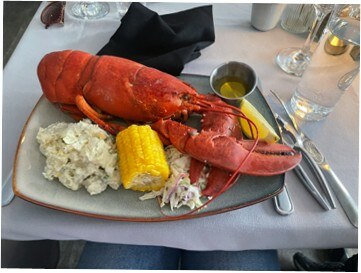 A whole lobster with corn, potato salad and drawn butter served at Hall's Harbour Lobster Pound