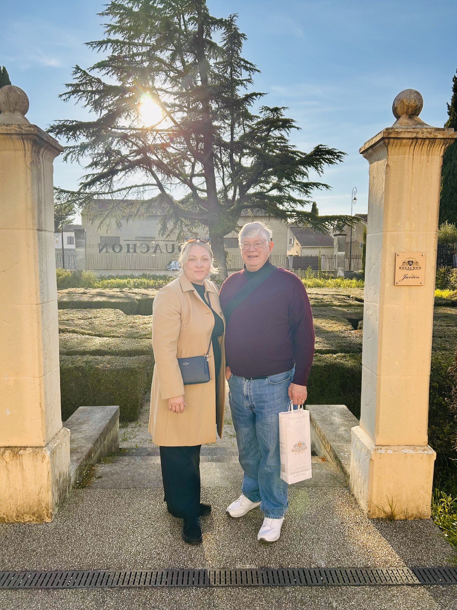 Sarah and Lewis standing at the garden entrance of the Bouachon winery near Châteauneuf-du-Pape