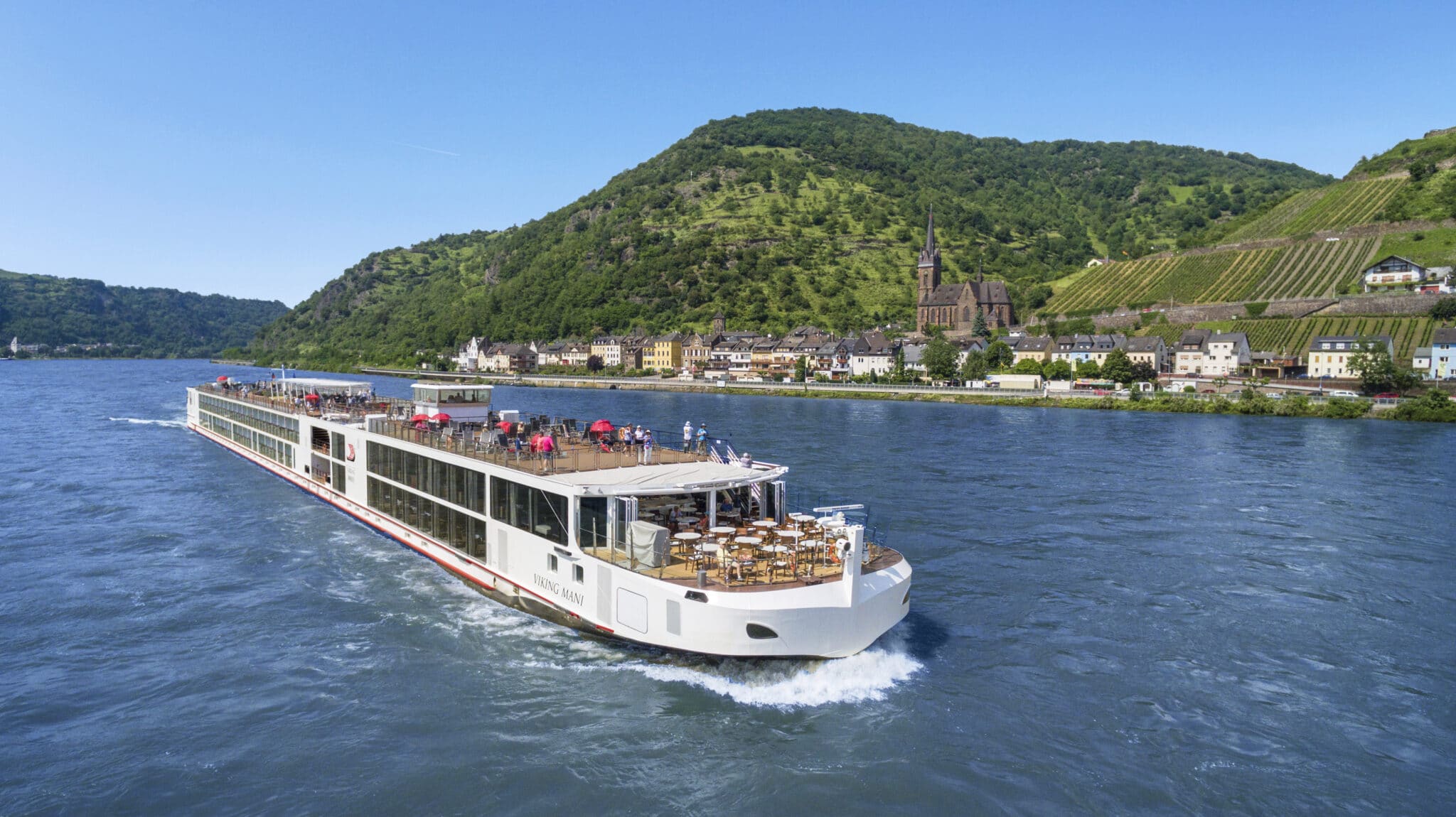 Viking river cruise ship sailing the Middle Rhine past vineyard-covered hills