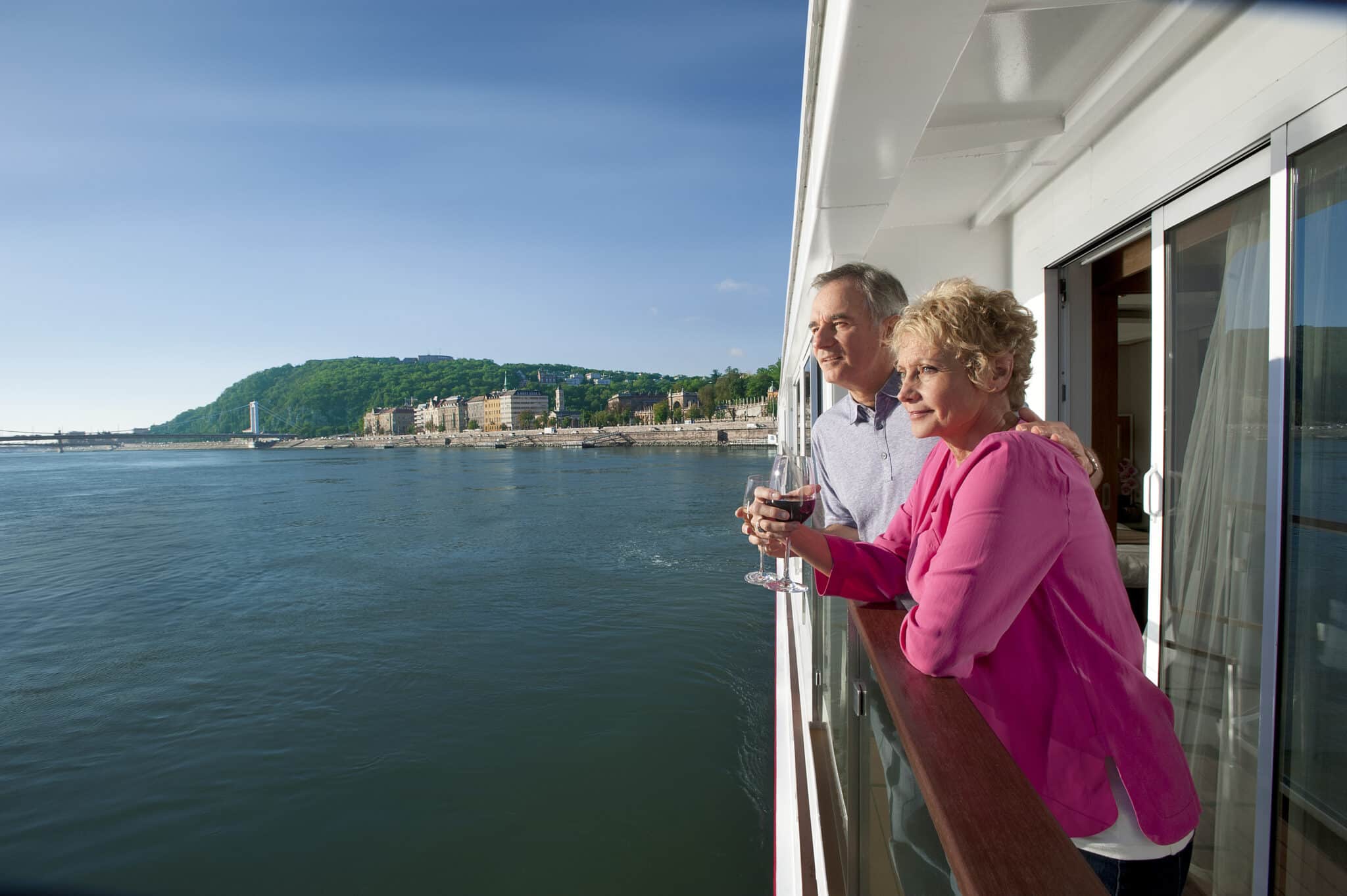 Couple enjoying wine on a river cruise ship veranda