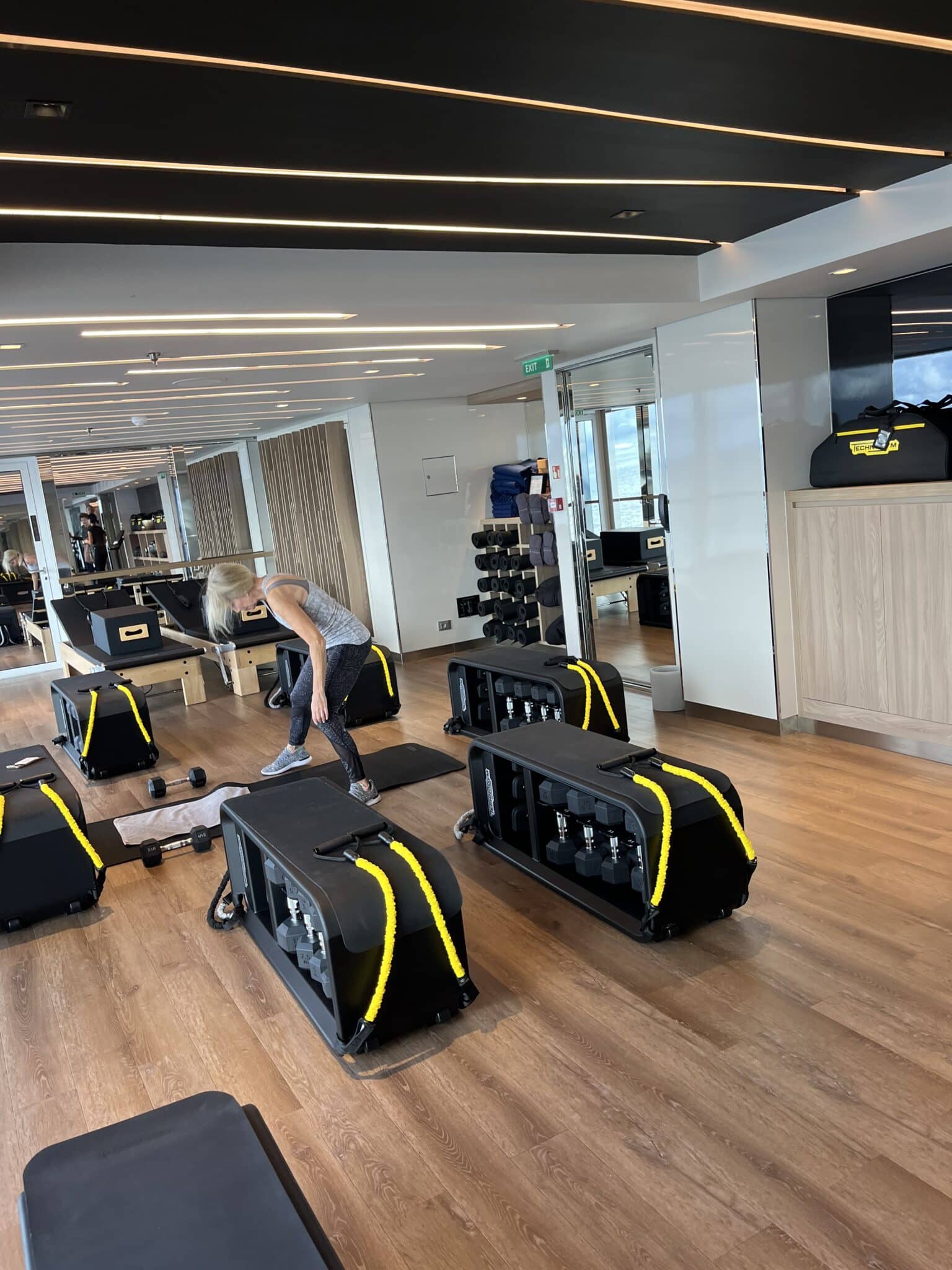 Guests in a group fitness class using Technogym equipment aboard Explora Journeys